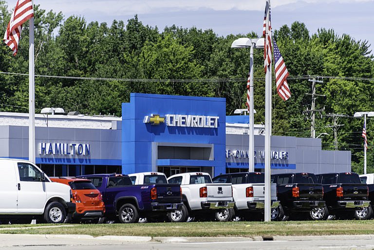 A car dealership with a large blue sign that says 
