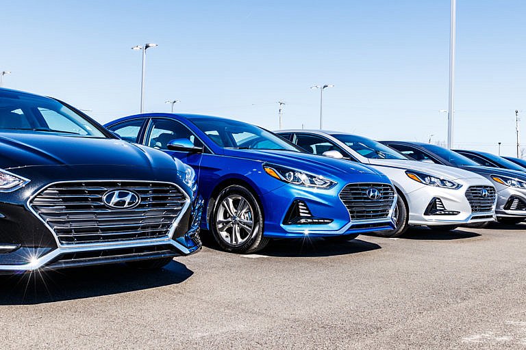 Line of Hyundai vehicles at a dealership.