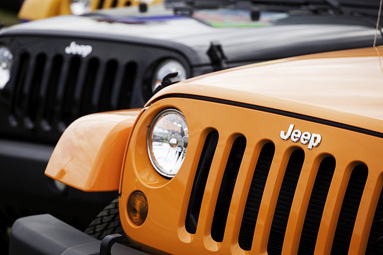 Parked yellow and black Jeep Wranglers