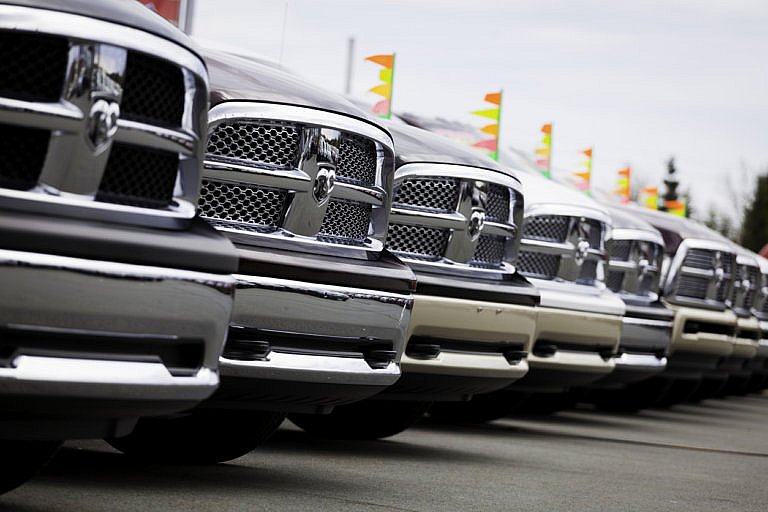 Dodge RAM trucks lined up at dealership.