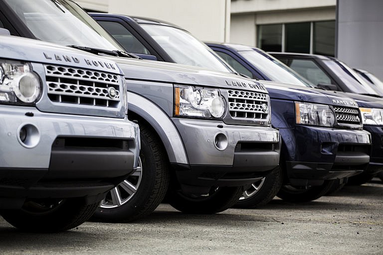 Line of Land Rovers and Range Rovers.
