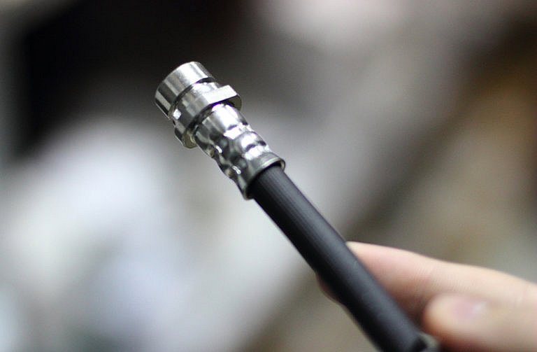 Close-up of a coaxial cable with a metal connector.