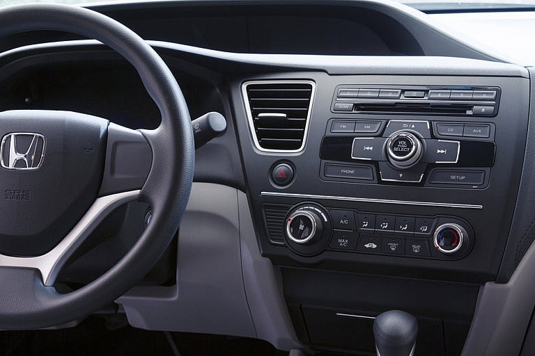 Honda car interior with steering wheel and dashboard controls.