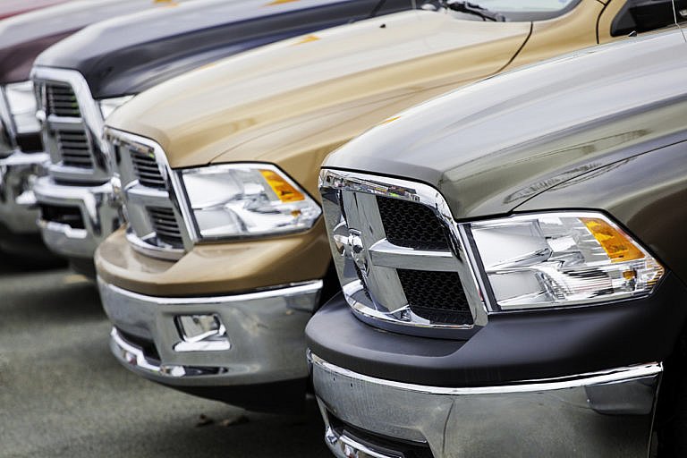 Row of Dodge Ram trucks in various colors.