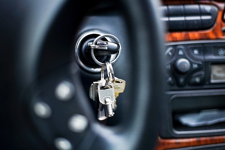 Car keys hanging from the ignition inside a vehicle.
