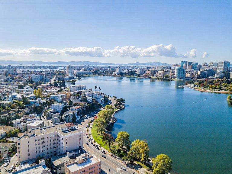 Aerial view of Lake Merritt with downtown Oakland skyline in the background.