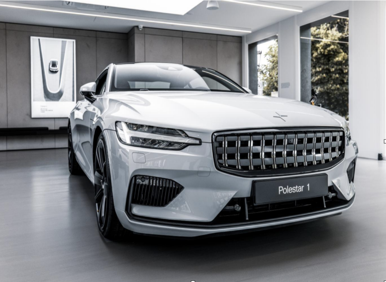 White Polestar 1 on display in a modern showroom.