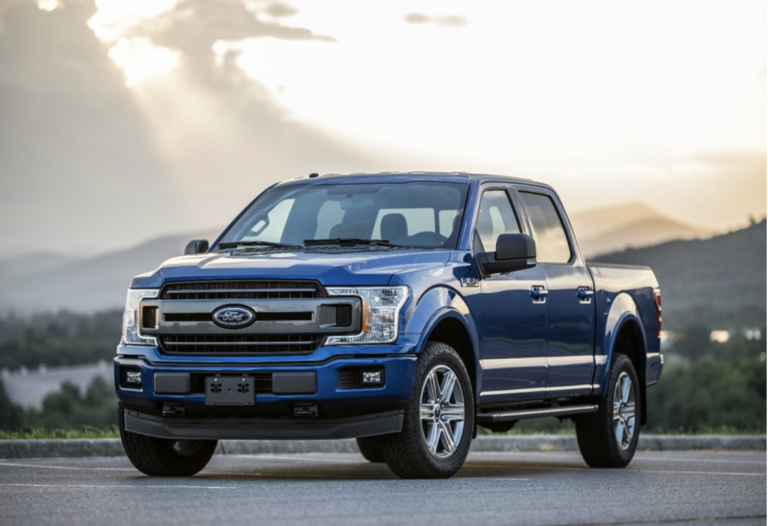 A blue Ford F-150 pickup truck is parked outdoors.