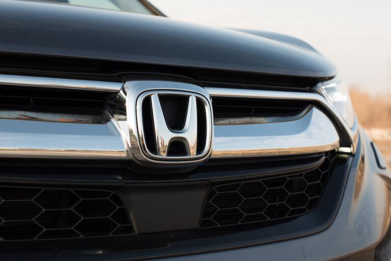 Close-up of a Honda vehicle's front grille, featuring the iconic chrome emblem.