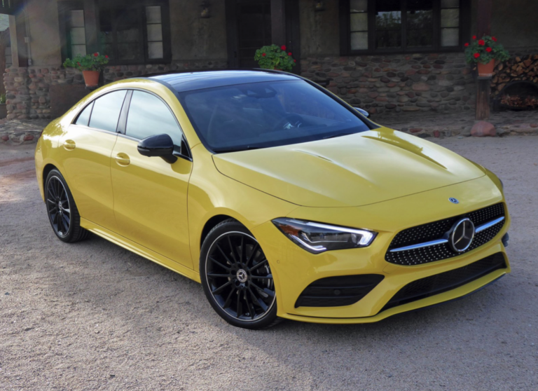 A yellow Mercedes-Benz parked outdoors.