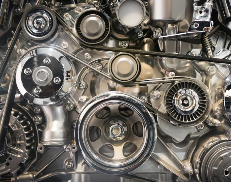 A close-up of a polished car engine with metal parts.