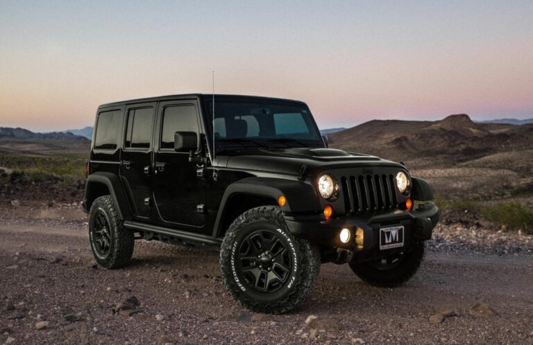 jeep wranglerBlack Jeep Wrangler parked in the desert at sunset.