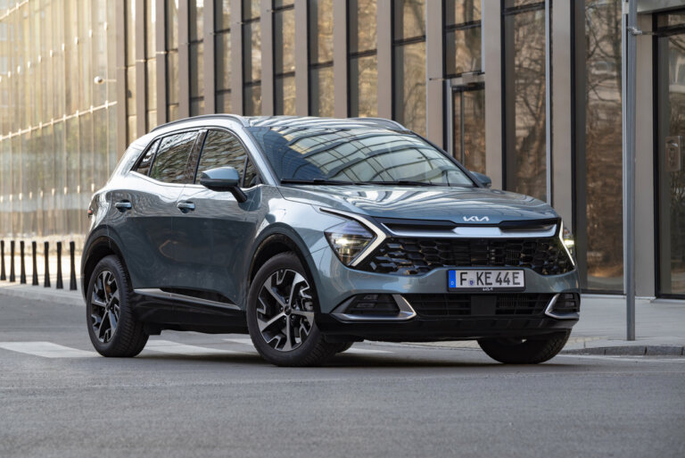 A Kia Sportage parked on a city street.