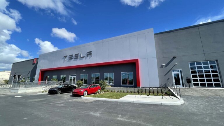 Tesla dealership building with parked cars outside