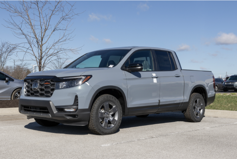 Alt-text suggestion: **Gray Honda Ridgeline pickup truck parked outdoors on a sunny day**