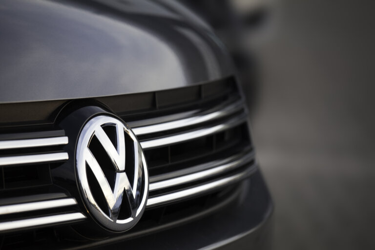 Close-up of a Volkswagen logo on a car grille.