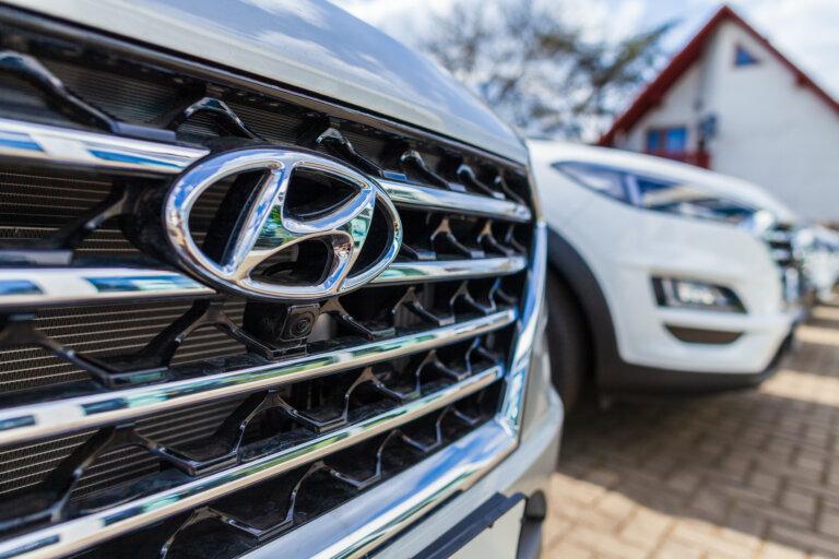 Close-up of a Hyundai car grille with the company logo in focus.