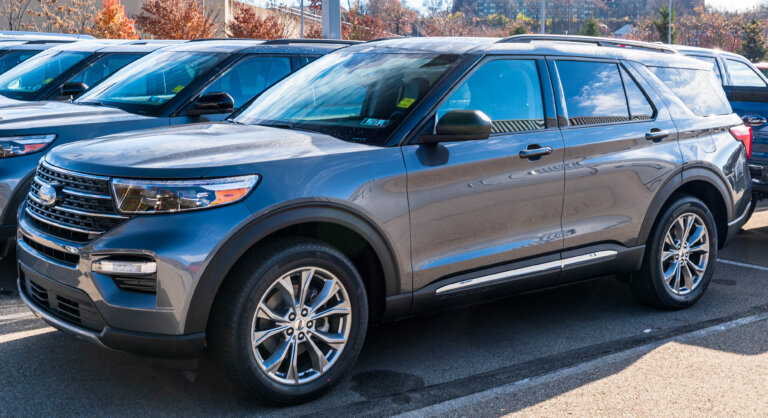A gray Ford SUV is parked in a dealership lot.