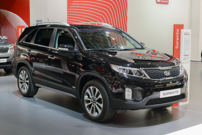 A black Kia Sorento SUV on display at a car show.