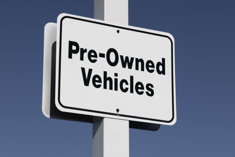 Pre-Owned Vehicle car sign at a dealership. With supply issues, used and preowned cars are in high demand.