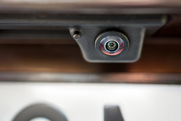 Close-up of a car’s rearview backup camera above the license plate.