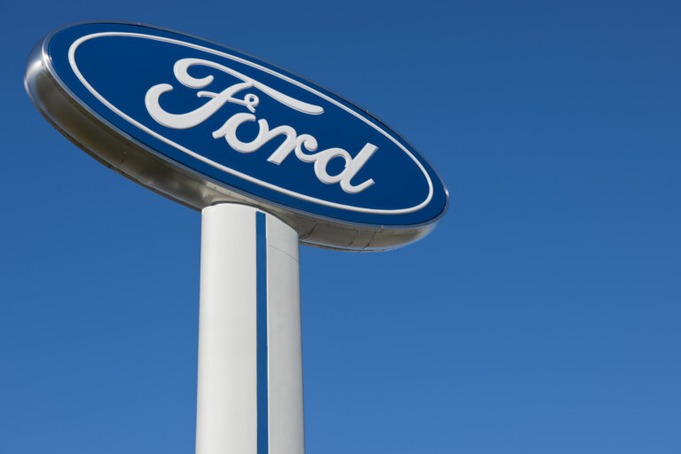 Ford dealership sign against a clear blue sky