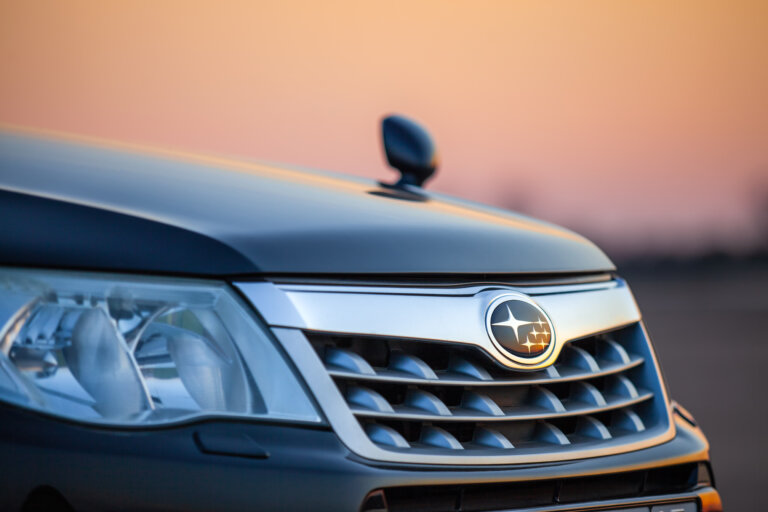 Subaru car front grille with logo at sunset