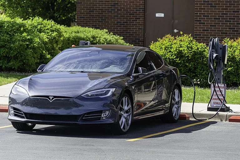 Tesla electric car charging at a station