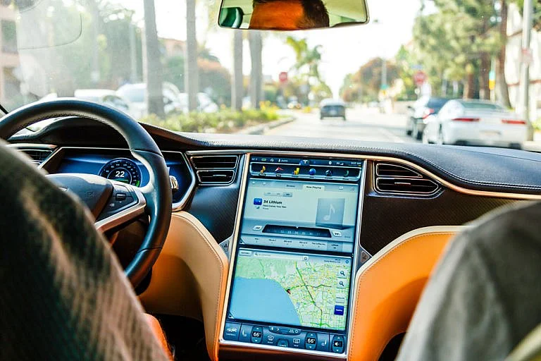 The interior of a Tesla shows its touchscreen navigation.