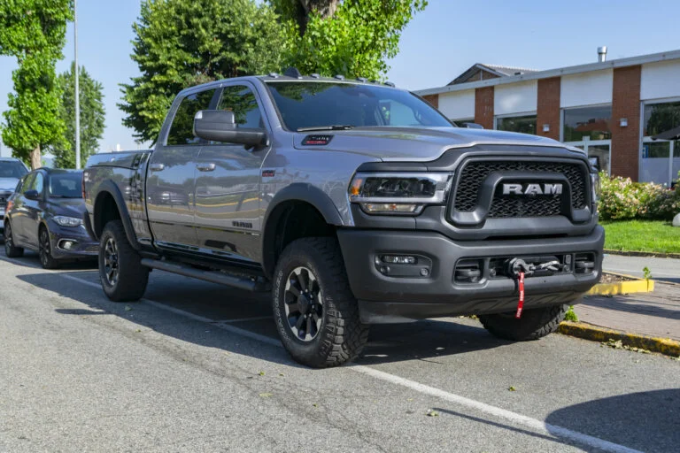 A gray RAM pickup truck is parked on a street.