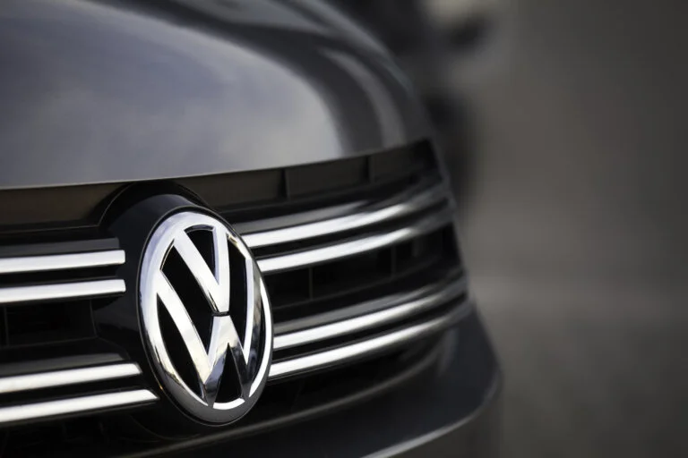 Close-up of a Volkswagen logo on a car grille.