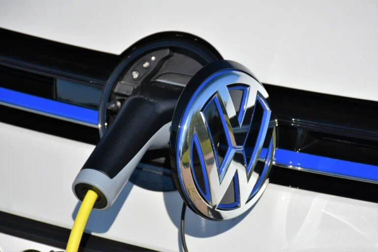 Volkswagen electric car charging port with plug connected.