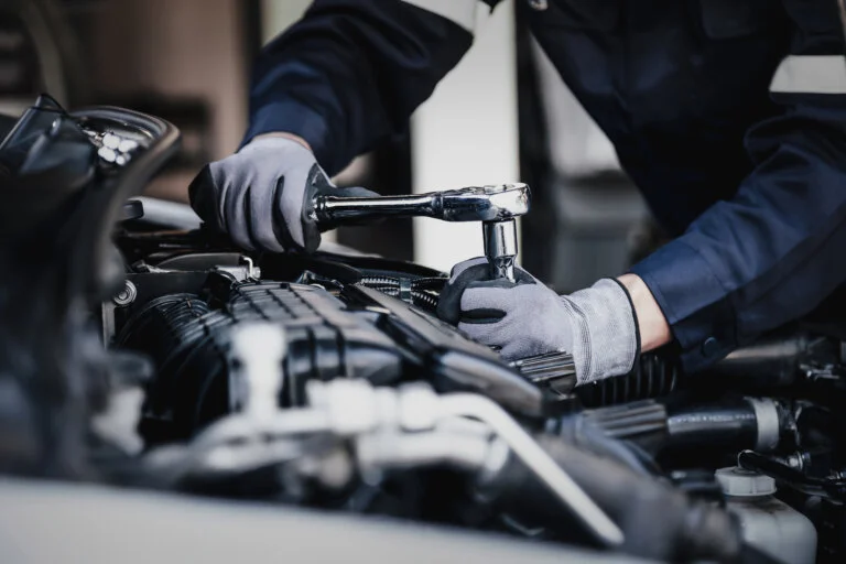 Mechanic working on car engine