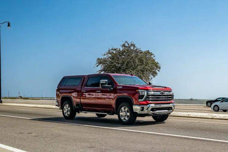 Red Chevrolet pickup on coastal highway