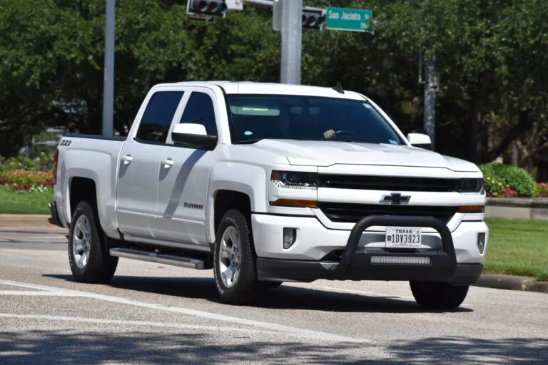 White Chevrolet Silverado pickup truck on a city street