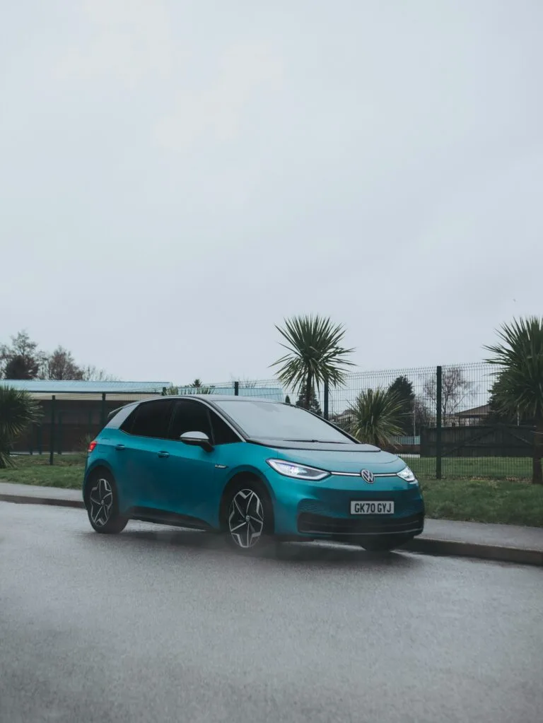 Blue Volkswagen electric car parked on a roadside