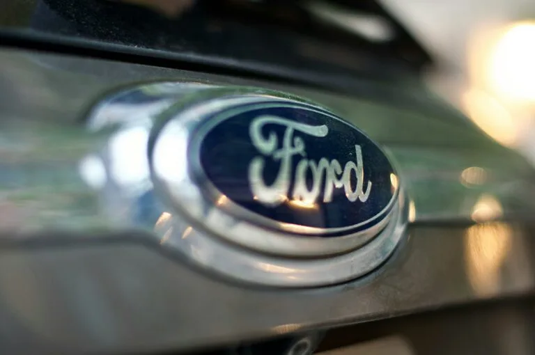 Close-up of the Ford logo on a vehicle, accompanying information about the 2026 F-150 recall.