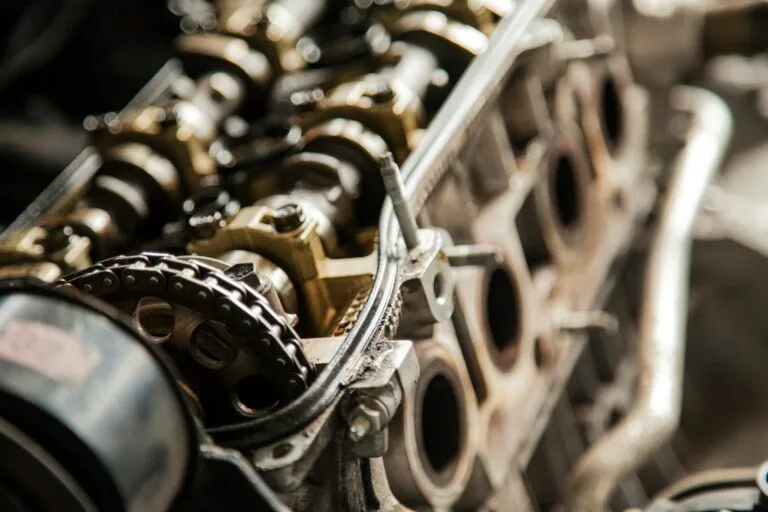 Close-up of an exposed GM 6.2L V8 engine showing its timing chain and cylinder head components.