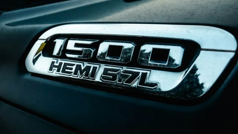 Close-up of a vehicle badge labeled “1500 HEMI 5.7L.”